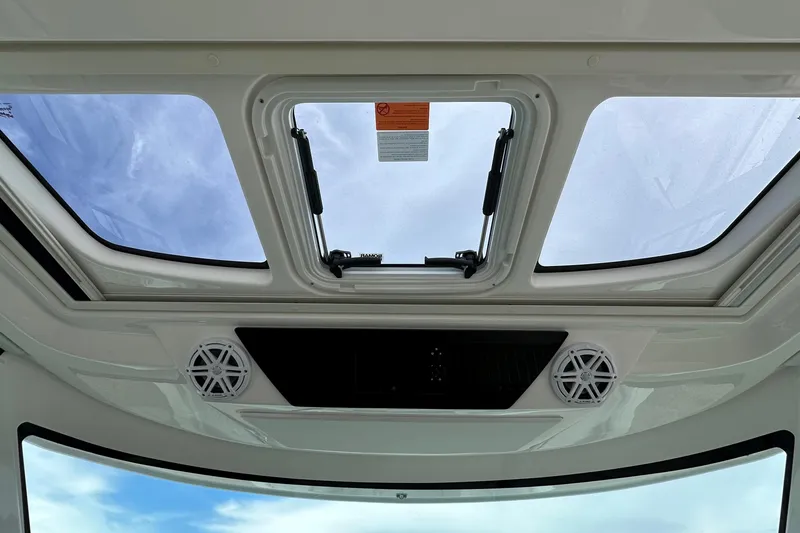 Slide: The Image of 2026 Tiara Yachts 48 LS skylight view with speakers and open hatch. - 26