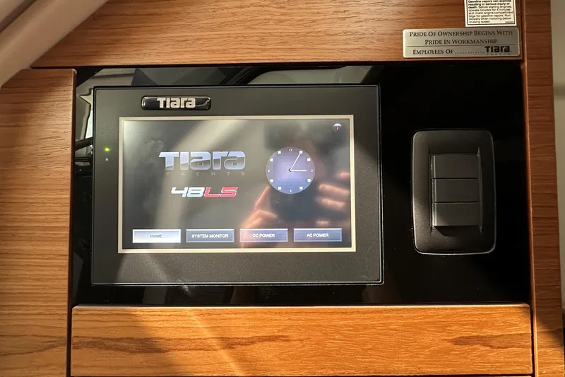 Slide: The Image of Touchscreen control panel of 2026 Tiara Yachts 48 LS, featuring system monitor and power options. - 27
