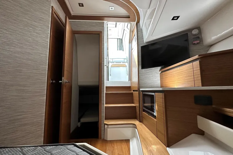 Slide: The Image of Interior of 2026 Tiara Yachts 48 LS, featuring modern wood finishes and sleek design. - 28