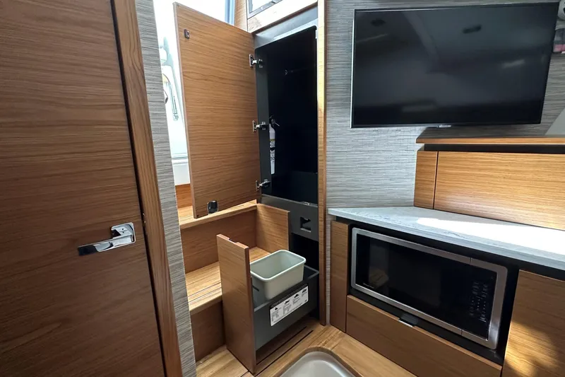 Slide: The Image of Modern kitchen interior of 2026 Tiara Yachts 48 LS with wood cabinetry and appliances. - 29