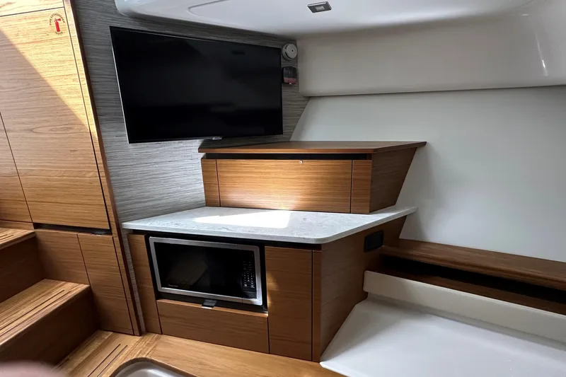 Slide: The Image of Modern interior of 2026 Tiara Yachts 48 LS with TV and microwave. - 30