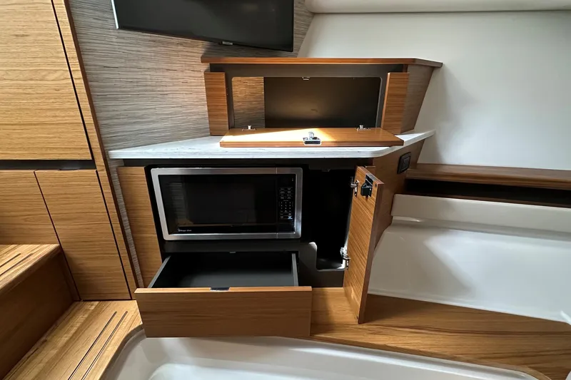 Slide: The Image of 2026 Tiara Yachts 48 LS interior with microwave and wooden cabinetry. - 31