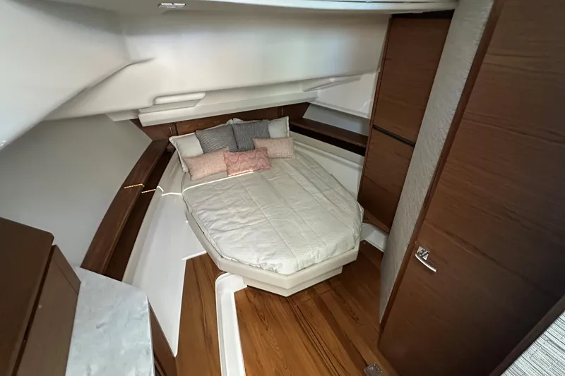 Slide: The Image of Luxurious cabin interior of 2026 Tiara Yachts 48 LS with cozy bed and wooden accents. - 32