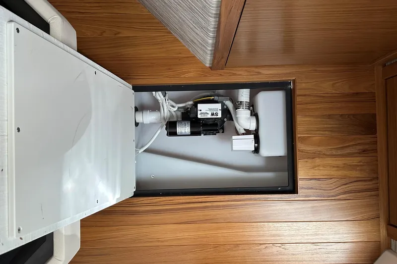 Slide: The Image of Bilge pump system in 2026 Tiara Yachts 48 LS, installed on wooden flooring. - 34