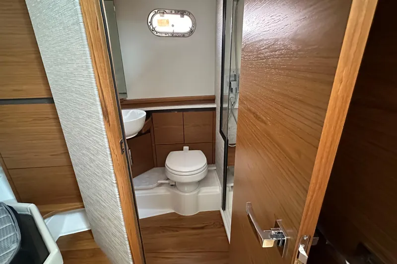Slide: The Image of Luxurious bathroom in 2026 Tiara Yachts 48 LS, featuring modern wood finishes and compact design. - 35