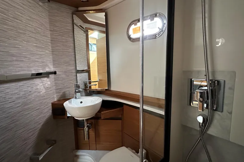 Slide: The Image of Luxurious bathroom interior of 2026 Tiara Yachts 48 LS with modern fixtures and wood accents. - 36