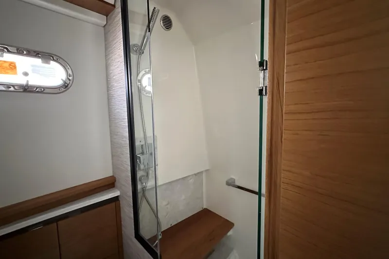Slide: The Image of Modern bathroom interior of 2026 Tiara Yachts 48 LS with wooden accents and glass shower. - 37
