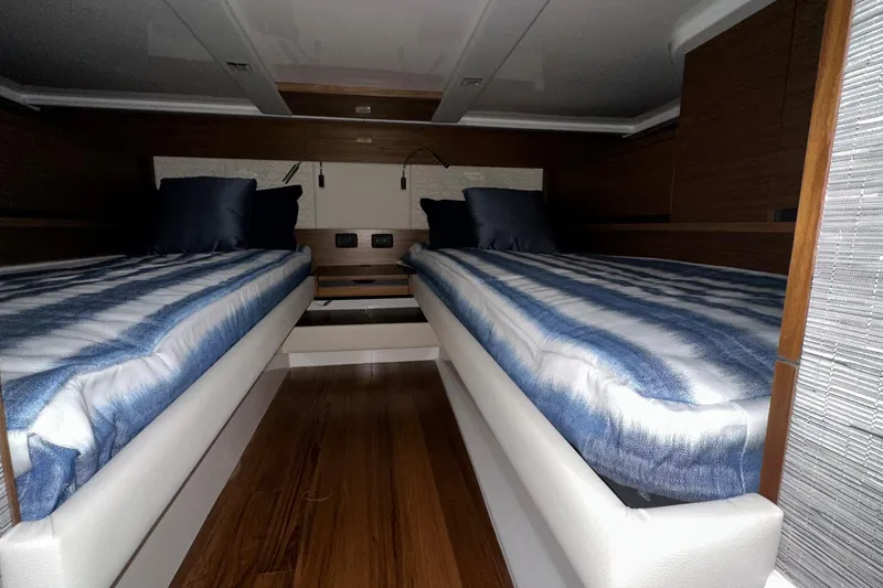 Slide: The Image of 2026 Tiara Yachts 48 LS cabin with twin beds and modern interior design. - 38