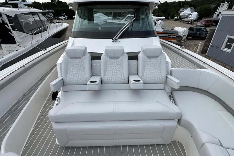 Slide: The Image of 2026 Tiara Yachts 48 LS luxury seating area with modern design and cup holders. - 47