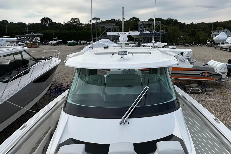 Slide: The Image of 2026 Tiara Yachts 48 LS on display, featuring sleek design and advanced Garmin navigation. - 49