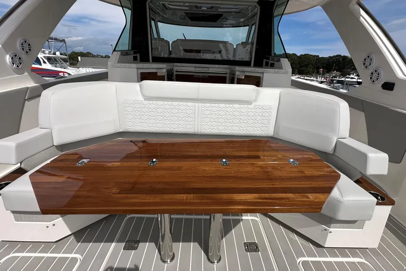 Slide: The Image of Luxurious seating area on 2026 Tiara Yachts 48 LS with elegant wooden table. - 5