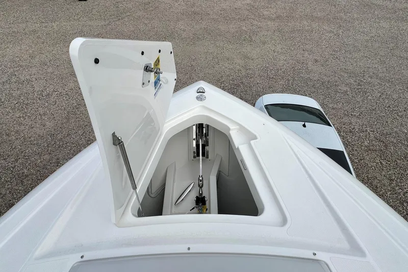 Slide: The Image of 2026 Tiara Yachts 48 LS bow storage compartment open, showcasing interior details. - 50