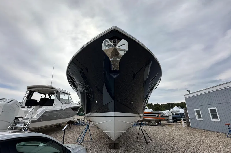 Slide: The Image of 2026 Tiara Yachts 48 LS boat displayed outdoors on gravel lot. - 51