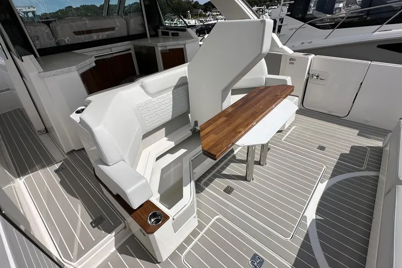 Slide: The Image of 2026 Tiara Yachts 48 LS interior with elegant seating and wooden table. - 6