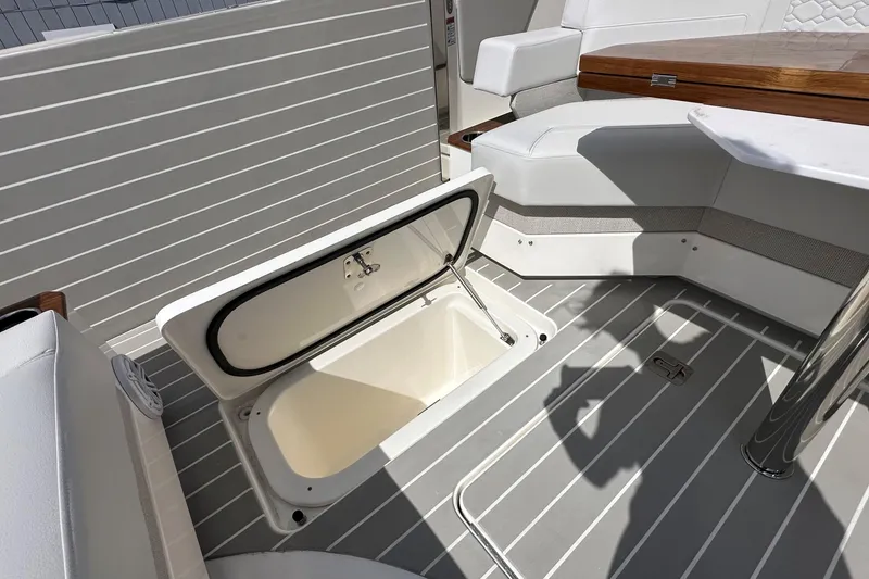 Slide: The Image of 2026 Tiara Yachts 48 LS interior with open storage compartment and seating area. - 7