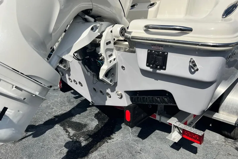 Slide: The Image of 2026 Key West 263 FS boat stern with outboard motor and trailer. - 11