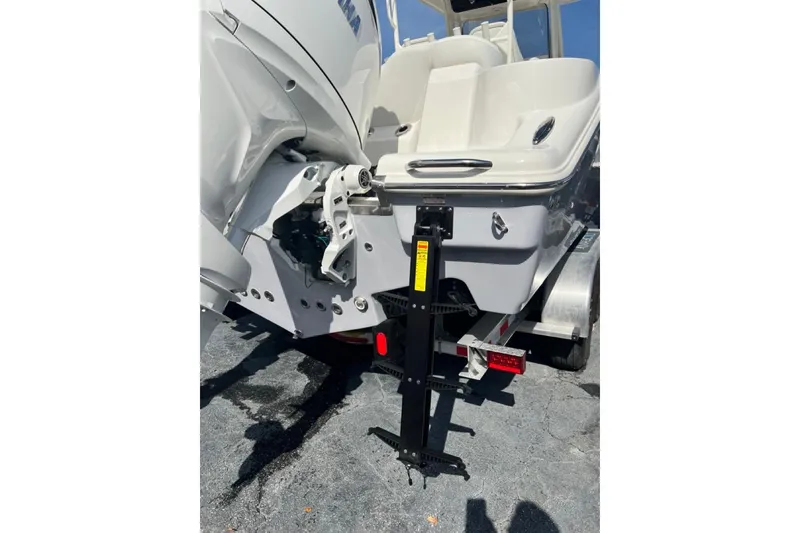 Slide: The Image of 2026 Key West 263 FS boat rear view on trailer, showcasing engine and hull design. - 12