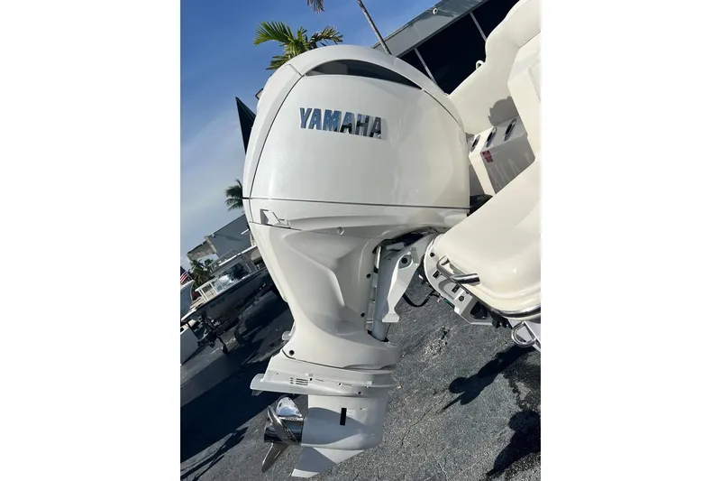 Slide: The Image of Yamaha outboard motor on 2026 Key West 263 FS boat, sunny day, palm tree background. - 13