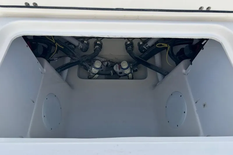 Slide: The Image of Storage compartment of 2026 Key West 263 FS boat, showing internal wiring and plumbing. - 20