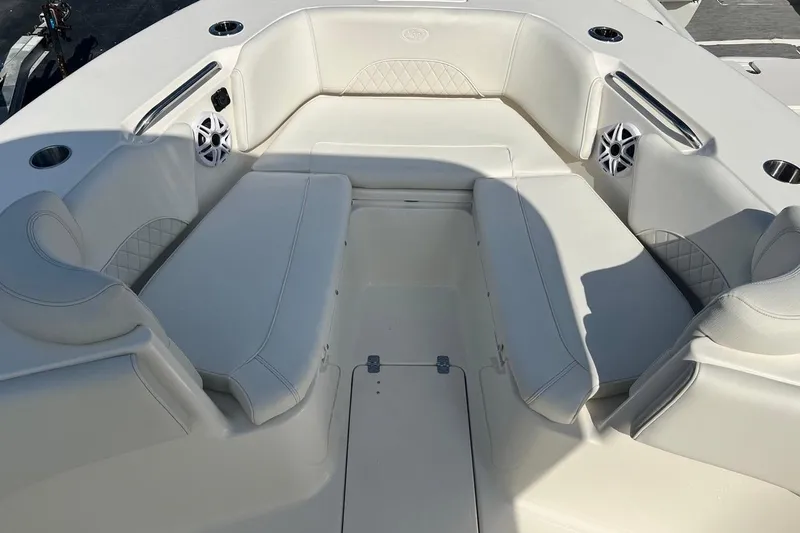 Slide: The Image of Luxurious seating area on 2026 Key West 263 FS boat, featuring white upholstery and speakers. - 23