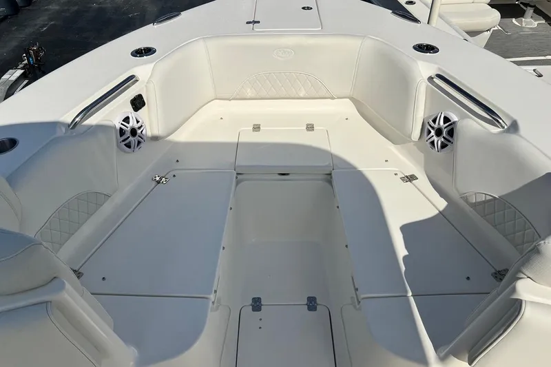 Slide: The Image of 2026 Key West 263 FS boat interior with white seating and built-in speakers. - 25