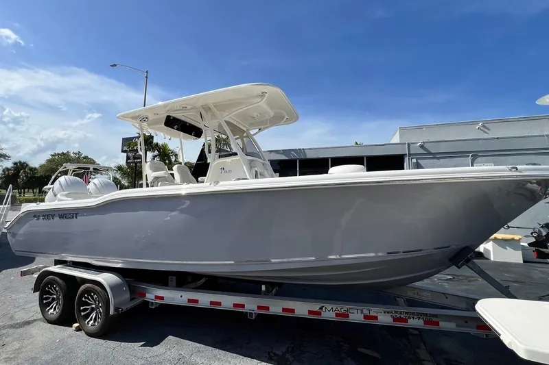 Slide: The Image of 2026 Key West 263 FS boat on trailer under clear blue sky. - 3