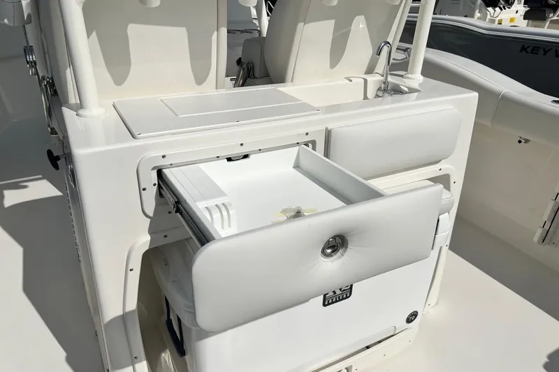 Slide: The Image of 2026 Key West 263 FS boat interior with open storage compartment and seating. - 32