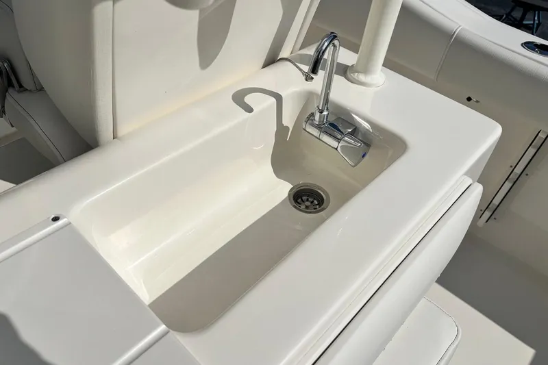Slide: The Image of 2026 Key West 263 FS boat sink with chrome faucet and white finish. - 34