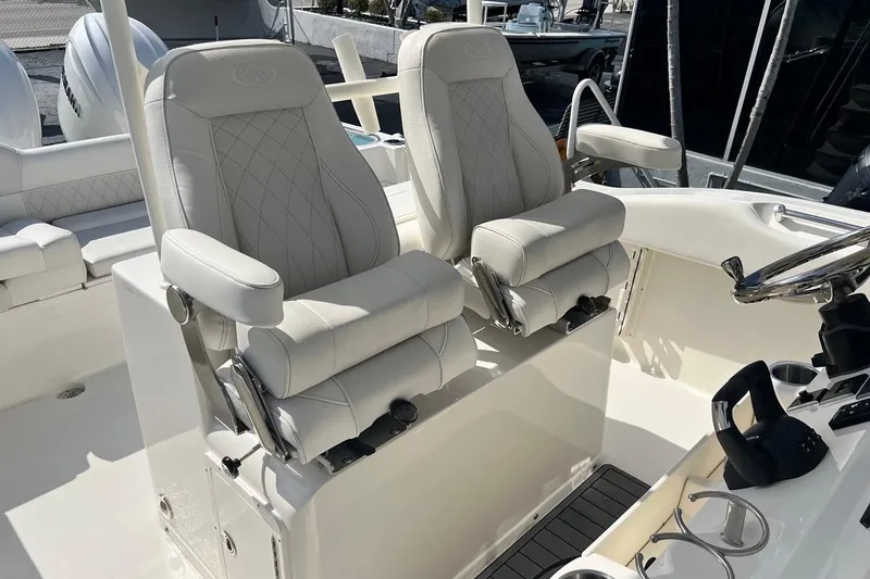 Slide: The Image of Luxury seating on 2026 Key West 263 FS boat, featuring plush white captain chairs. - 35
