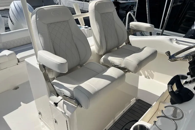 Slide: The Image of 2026 Key West 263 FS boat with luxurious white seating and modern helm design. - 36