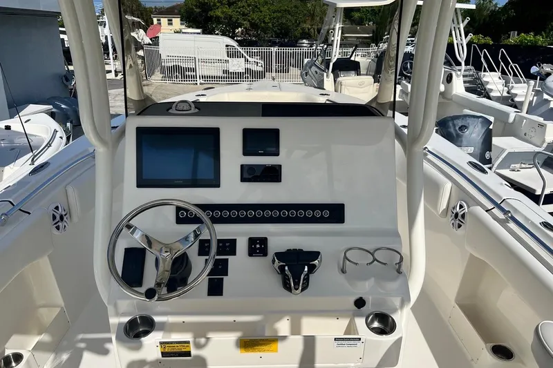 Slide: The Image of 2026 Key West 263 FS boat dashboard with steering wheel and electronic displays. - 37