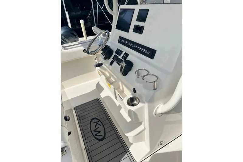 Slide: The Image of 2026 Key West 263 FS boat console with steering wheel, controls, and cup holders. - 38