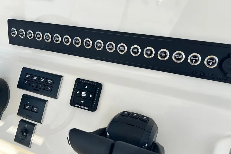 Slide: The Image of Control panel of 2026 Key West 263 FS boat with various switches and buttons. - 39