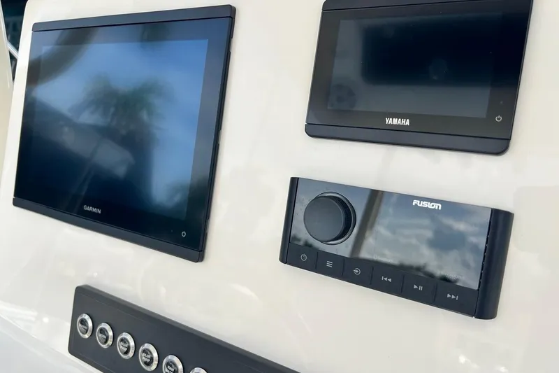 Slide: The Image of Control panel of 2026 Key West 263 FS boat with Garmin, Yamaha, and Fusion displays. - 40