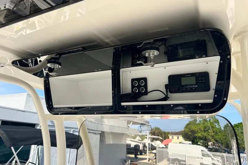 Slide: The Image of Overhead console of 2026 Key West 263 FS boat with electronic controls and radio. - 42