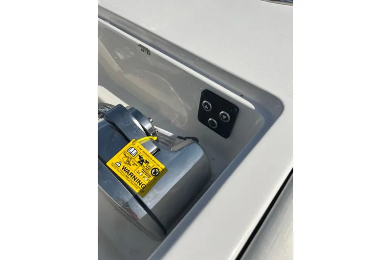 Slide: The Image of 2026 Key West 263 FS boat control panel with warning label and buttons. - 48