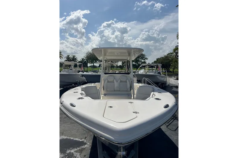 Slide: The Image of 2026 Key West 263 FS boat, sleek design, parked outdoors under a cloudy sky. - 5