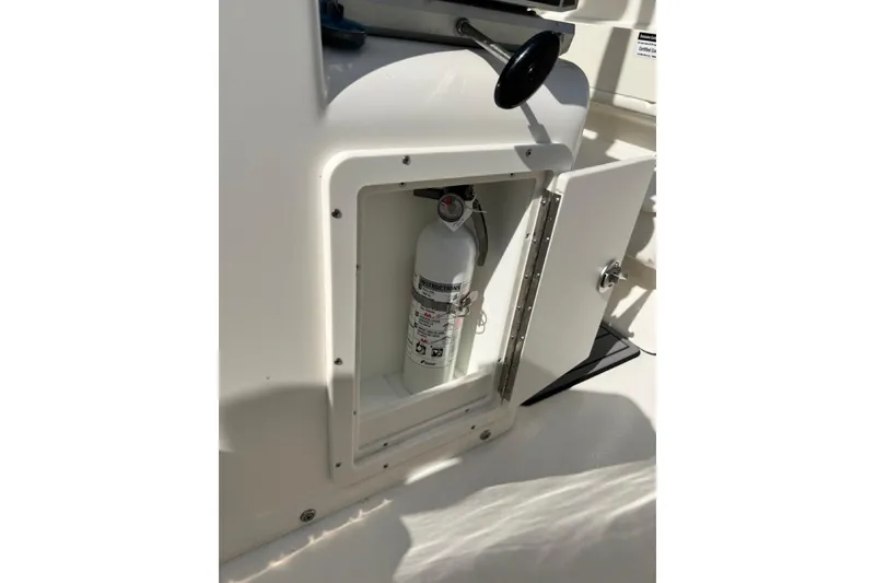 Slide: The Image of Fire extinguisher in storage compartment of 2026 Key West 263 FS boat. - 54