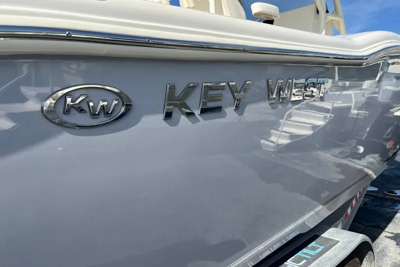 Slide: The Image of 2026 Key West 263 FS boat side view with logo and chrome lettering. - 56