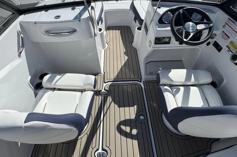 Slide: The Image of 2026 Stingray 191 DC boat interior with modern steering and comfortable seating. - 10
