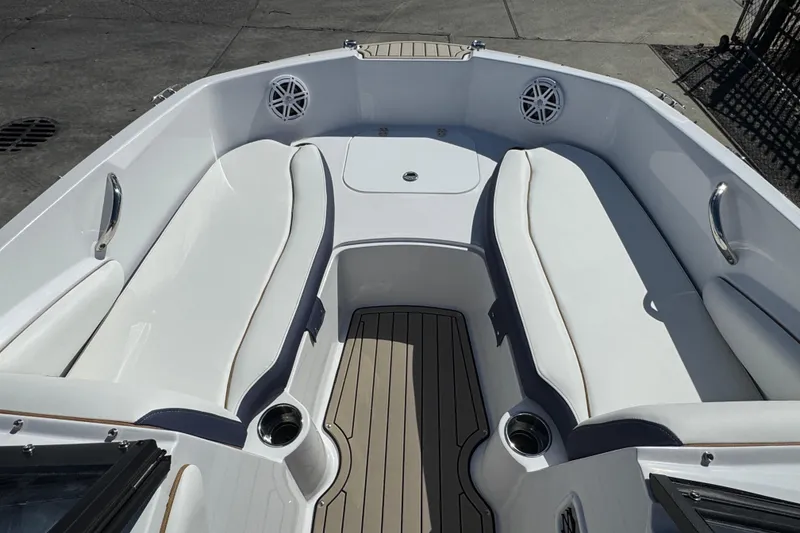Slide: The Image of 2026 Stingray 191 DC boat interior with white seating and cup holders. - 15