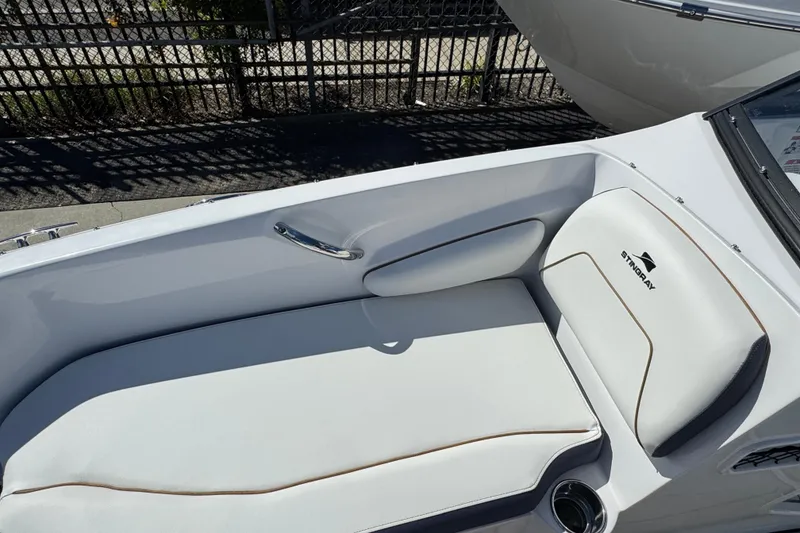 Slide: The Image of 2026 Stingray 191 DC boat interior with white cushioned seating and sleek design. - 17