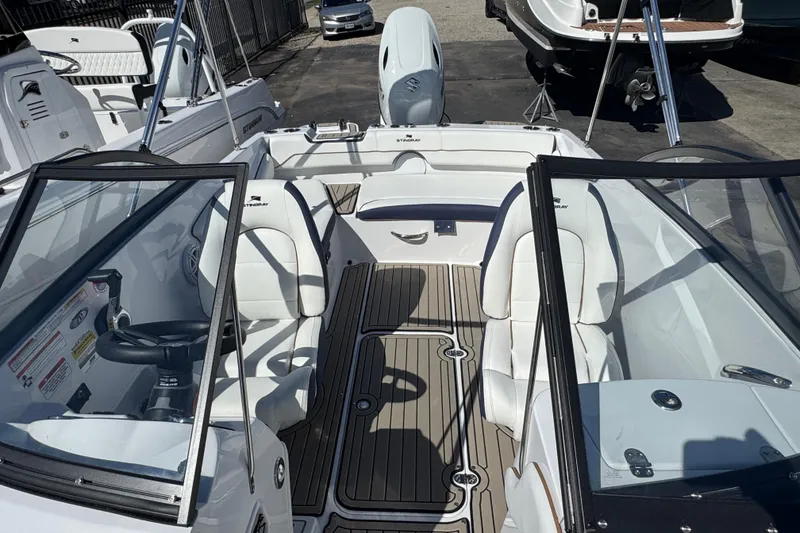 Slide: The Image of 2026 Stingray 191 DC boat interior with white seating and sleek design. - 19