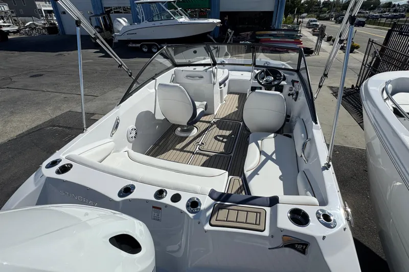 Slide: The Image of 2026 Stingray 191 DC boat interior with seating, steering wheel, and cup holders. - 3