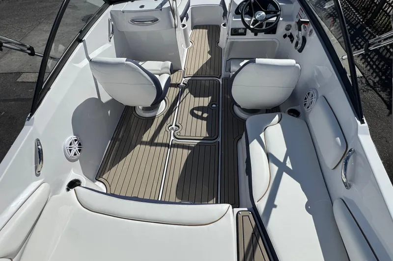 Slide: The Image of 2026 Stingray 191 DC boat interior with sleek seating and modern steering console. - 4
