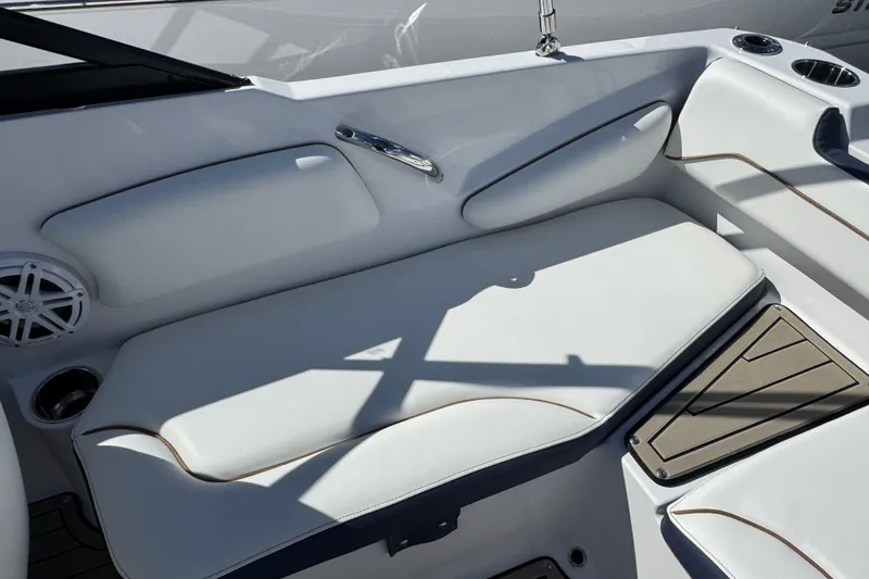 Slide: The Image of 2026 Stingray 191 DC boat interior with white cushioned seating and cup holders. - 6
