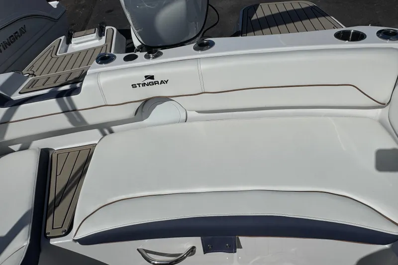 Slide: The Image of 2026 Stingray 191 DC boat interior with white seating and sleek design. - 7