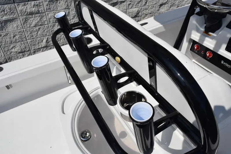 Slide: The Image of 2026 BlackJack 256 Coastal boat interior with cup holders and steering console. - 10