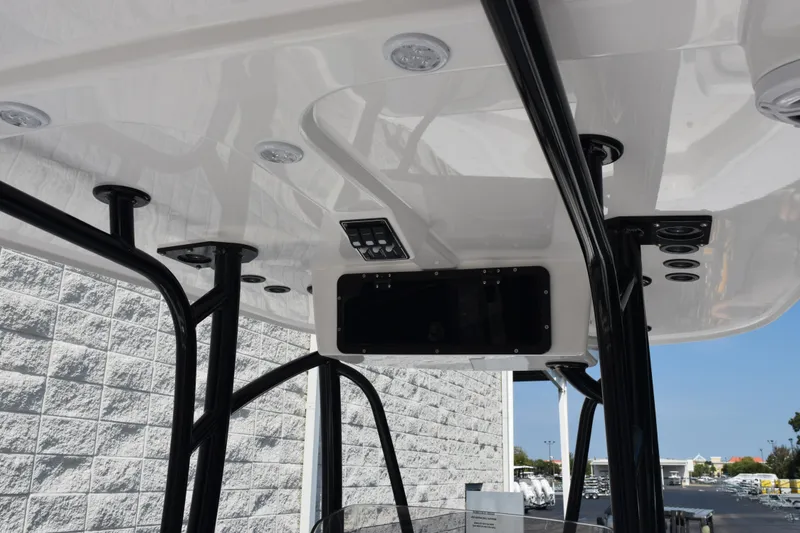 Slide: The Image of T-top interior of 2026 BlackJack 256 Coastal boat with lighting and control panel. - 12