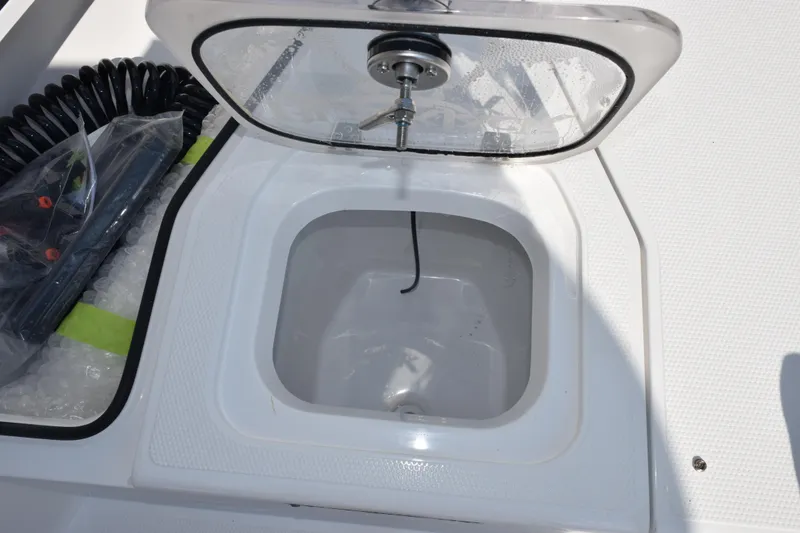 Slide: The Image of Open hatch on 2026 BlackJack 256 Coastal boat, showing storage compartment. - 18